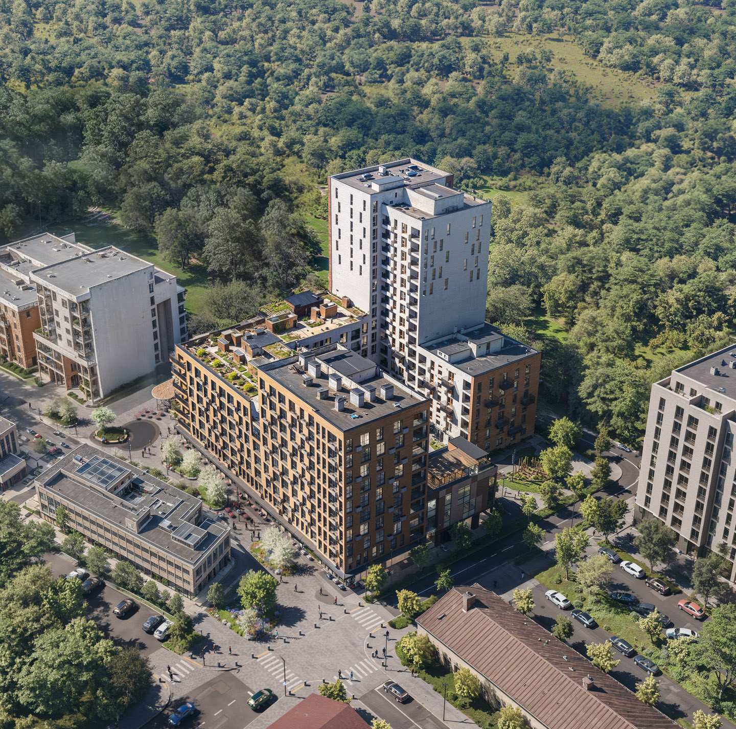 Aerial rendering of a modern residential complex with rooftop terraces, adjacent to a large forested park