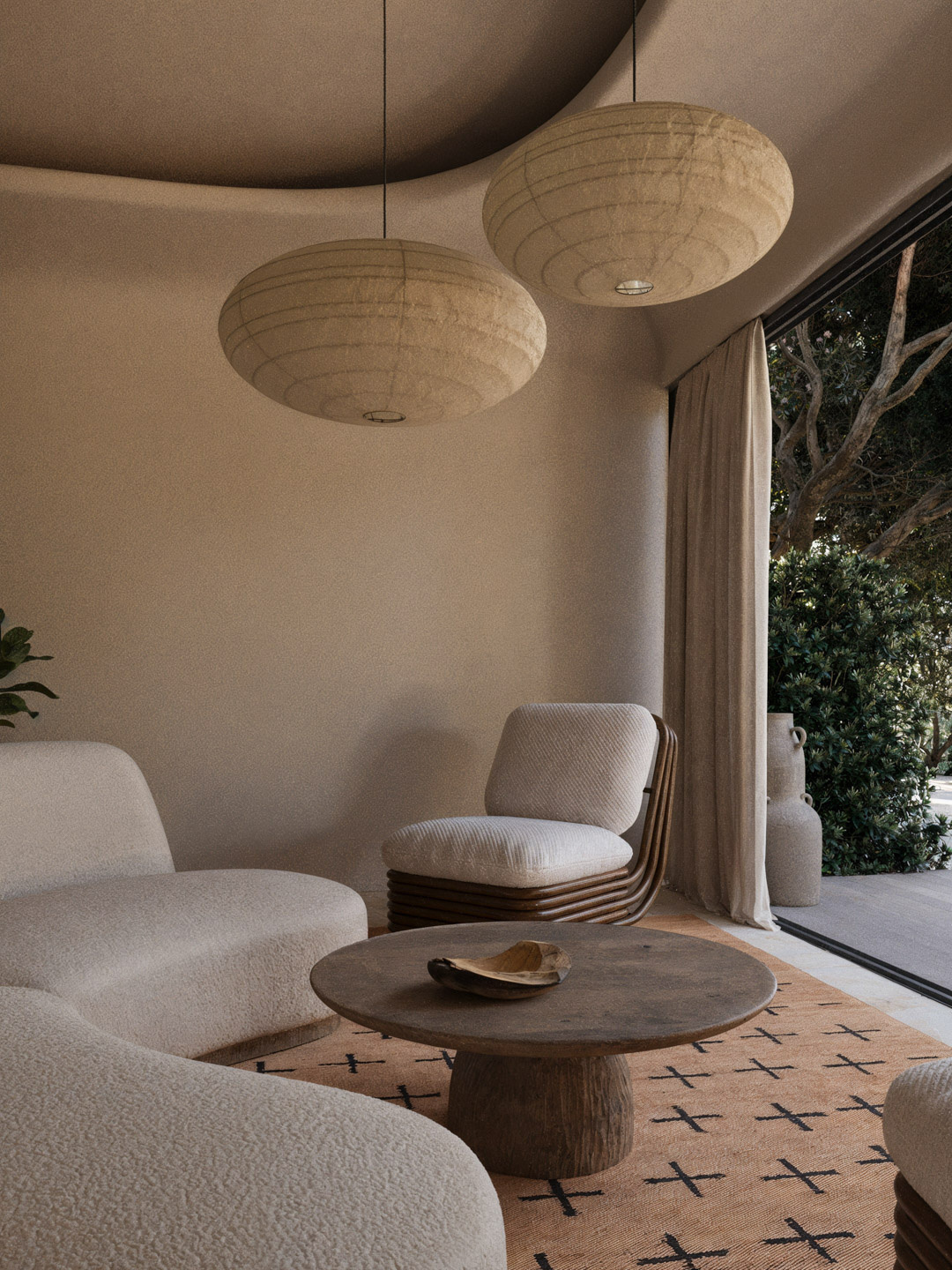 Mediterranean lounge with curved white boucle sofas, a sculptural wood base armchair, round textured pendant lights, and a rustic wooden coffee table on a terracotta rug with black cross pattern, opening to a garden view through floor-to-ceiling glass door