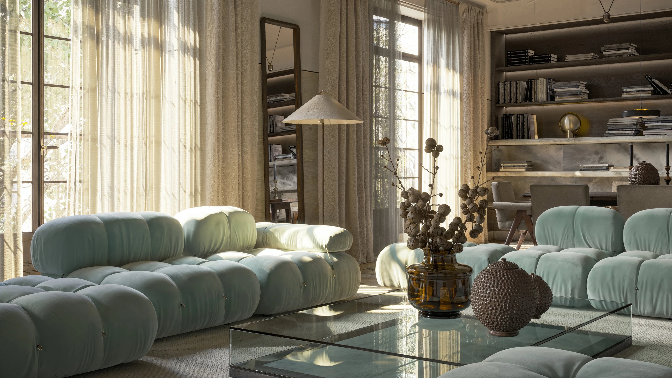 Mint velvet modular sofas in sun-drenched living room with sheer linen curtains and glass coffee table — architectural interior rendering