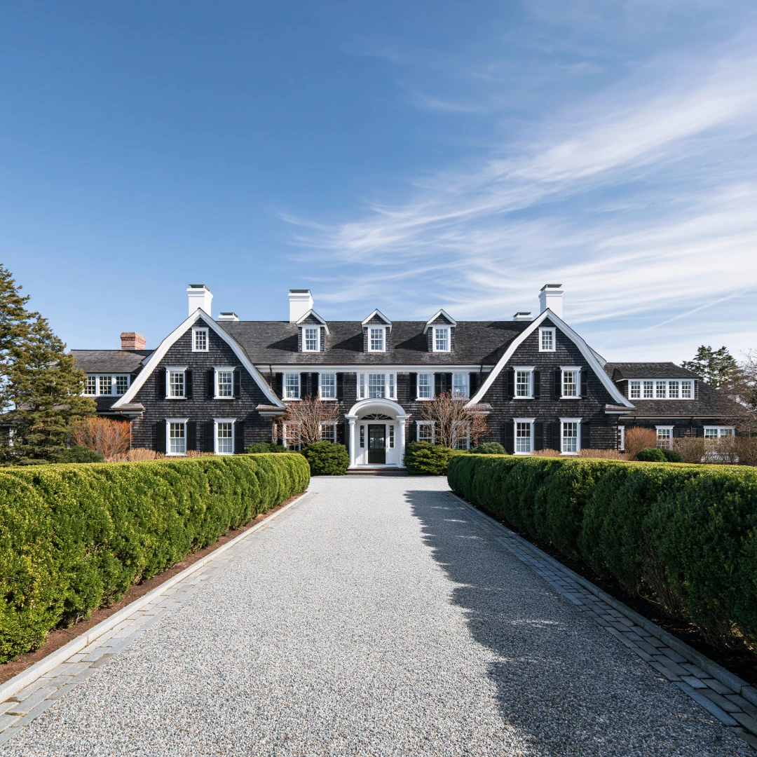 A single family residential home in Cape Cod style architecture with weathered cedar shingles and copper gutters