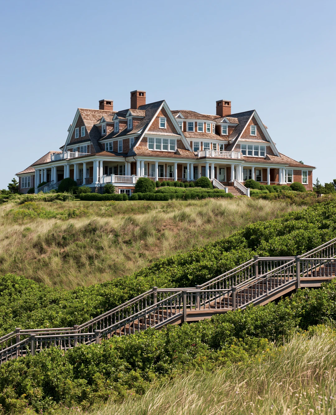 A single family residential home in Cape Cod style architecture with weathered cedar shingles and copper gutters